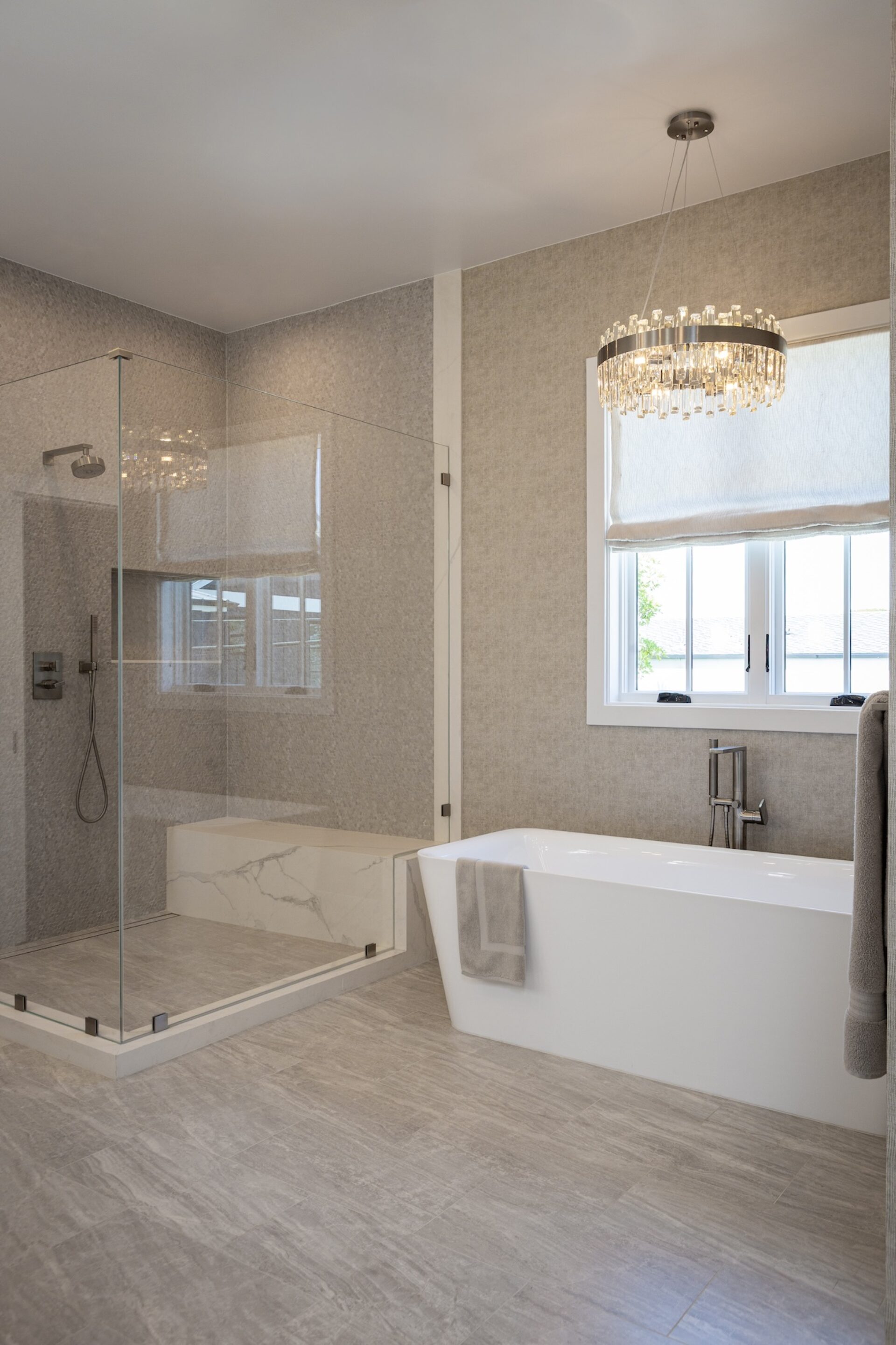 primary bathroom design chandelier over tub