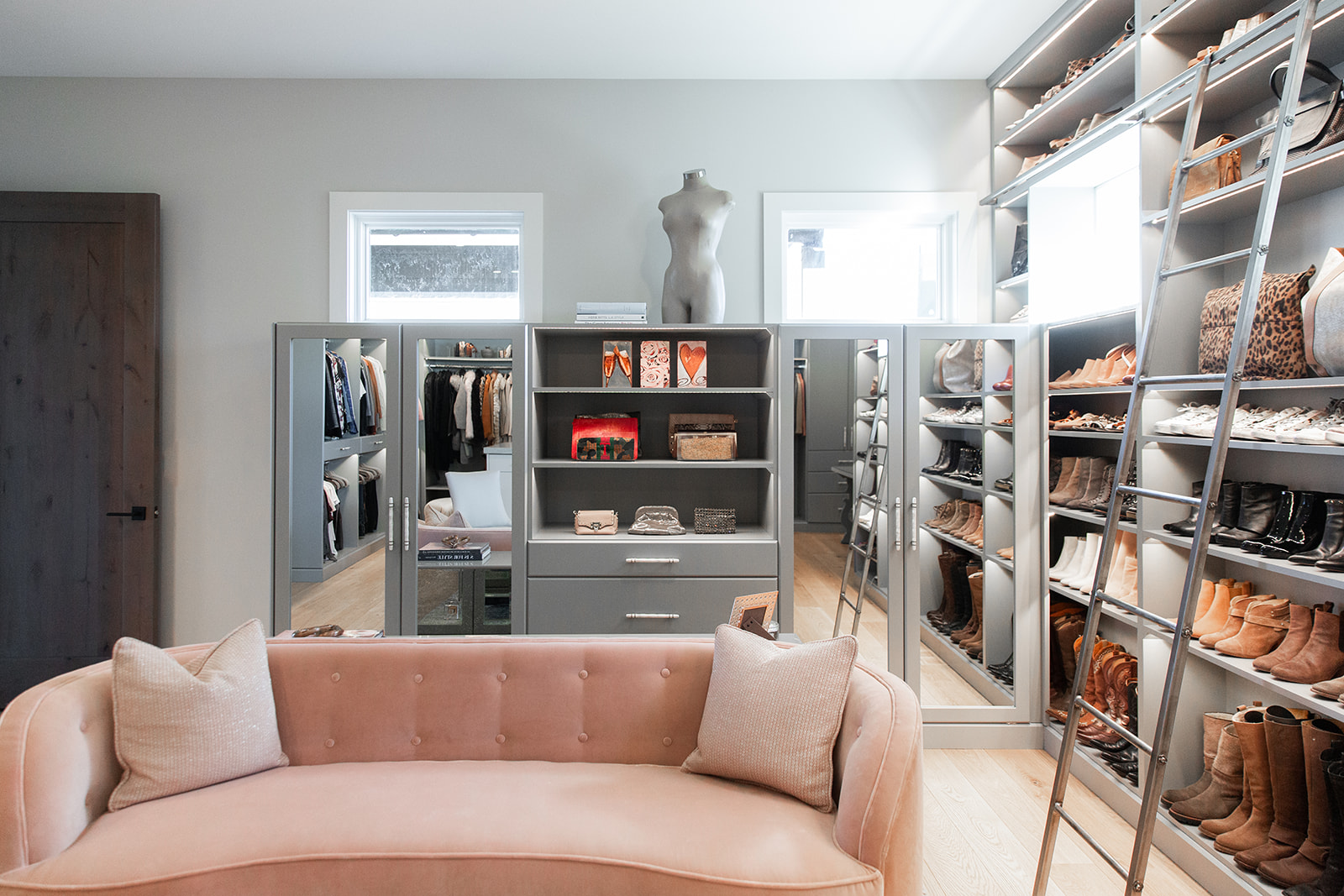 walk in closet with built in shelves ladder